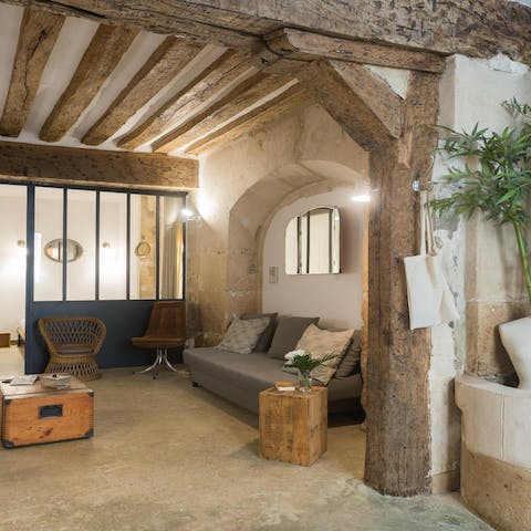 Snuggle up in the homely living space with rustic exposed beams and a brickwork archway   