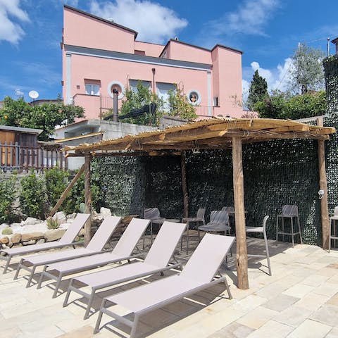 Soak up the sun on the terrace after a dip in the pool