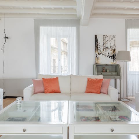 Relax in the Art Deco-inspired living space with exposed ceiling beams overhead