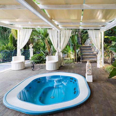 Take a seat in the sunken hot tub and enjoy the villa's tranquil location