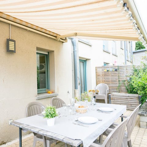 Dine alfresco under the retractable striped awning
