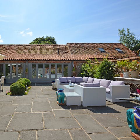 Entertain guests outside on a fine day in the communal garden area 