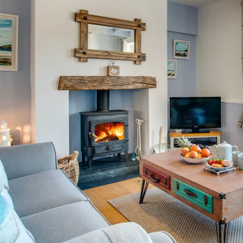 Curl up by the log-burning fire in the cosy lounge