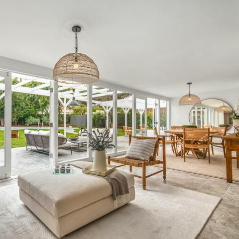 Admire the space and light in the sun room with dining area