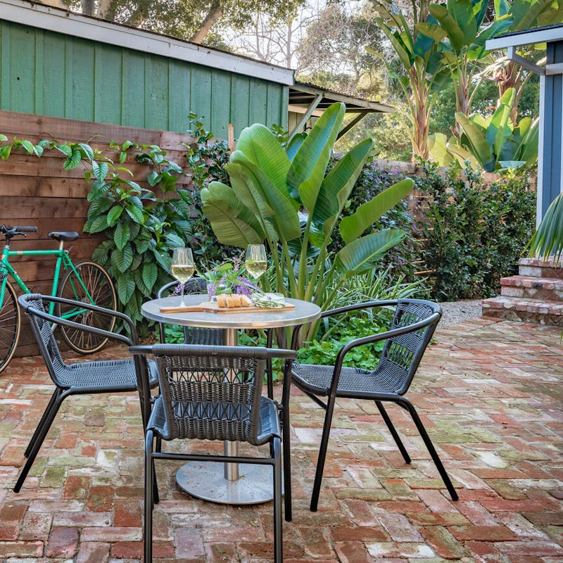 Dine alfresco in the paved and leafy yard