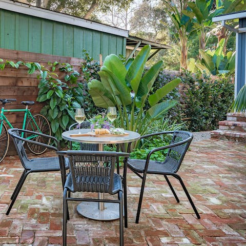 Dine alfresco in the paved and leafy yard