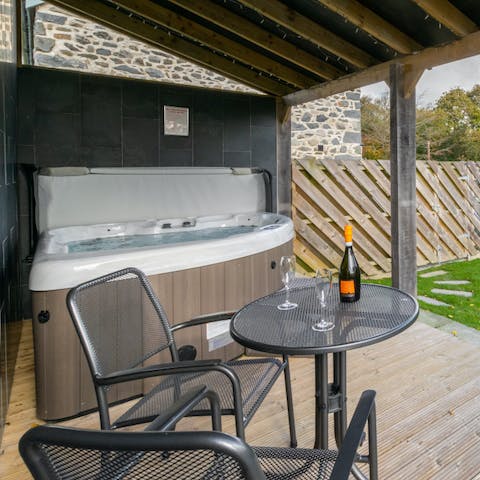 Relax and unwind in the hot tub and enjoy a glass of wine 