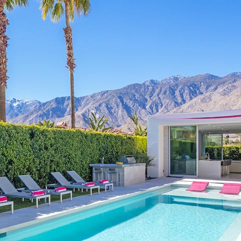 Relax by the glistening pool, with breathtaking mountain views around you 
