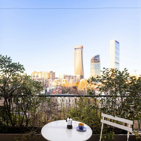 Take in the views over the city's modern architecture from the private balcony