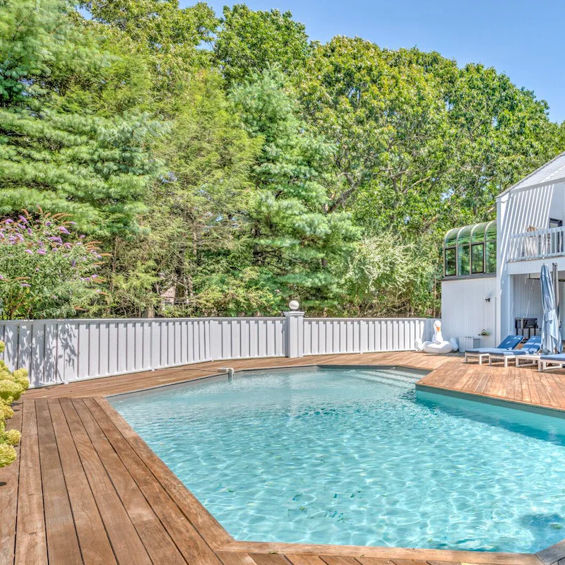 Swim in this lovely pool fringed by trees
