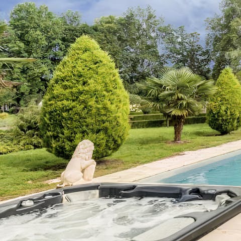 Unwind in the jacuzzi while admiring the stunning garden landscapes