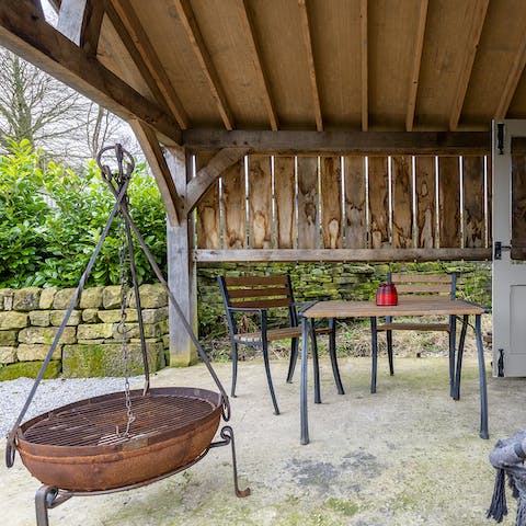 Cosy up outside around the covered fire pit come sundown