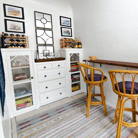 Perch on a bar stool with a glass of red from your host's wine collection