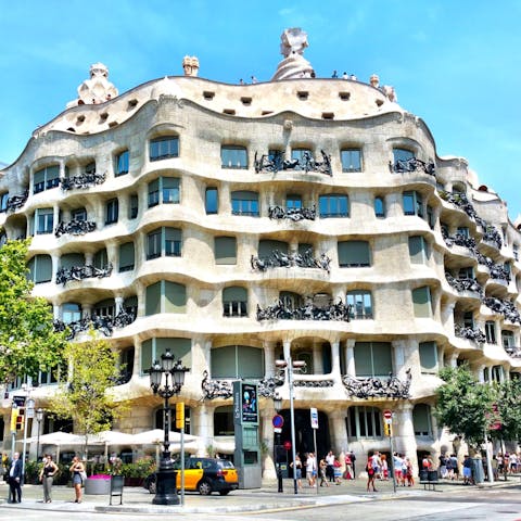 Visit Casa Milà, an eighteen-minute walk away