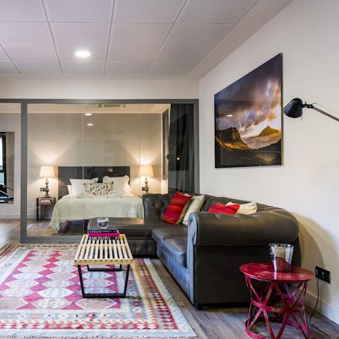 Kick back in the bright living room with a glass of Spanish wine after a day of exploring the city on foot