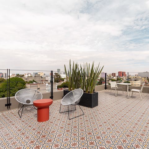 Head up to the shared rooftop terrace for morning coffee with a view
