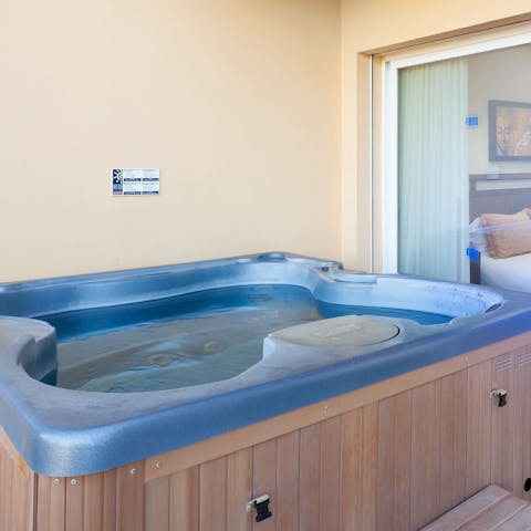 Relax in the private hot tub with a glass of cava