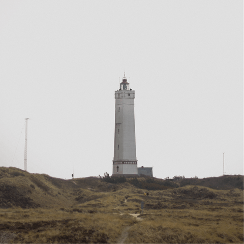 Visit the historic lighthouse, Blåvandshuk Fyr, a nine-minute drive away