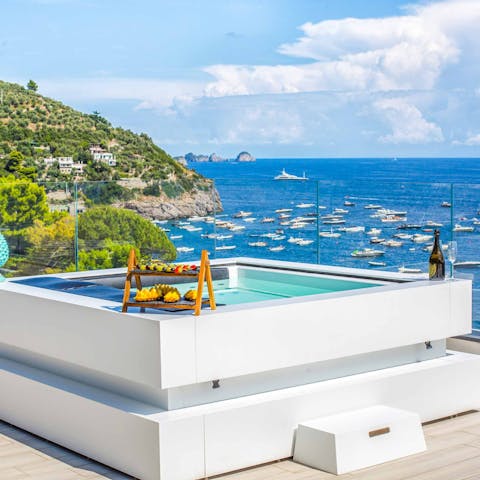 Relax and watch the boats bobbing on the ocean from the hot tub