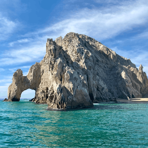 Take some snaps of the spectacular arching stone cliffs at Cabo San Lucas  