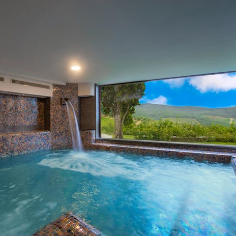 Indulge in a panoramic soak session in your indoor plunge pool