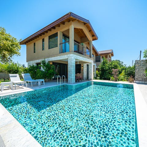 Take a dip in the mosaic style swimming pool 