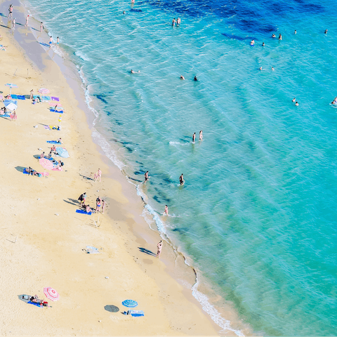 Listen to the waves lap the shore on Arenella Beach