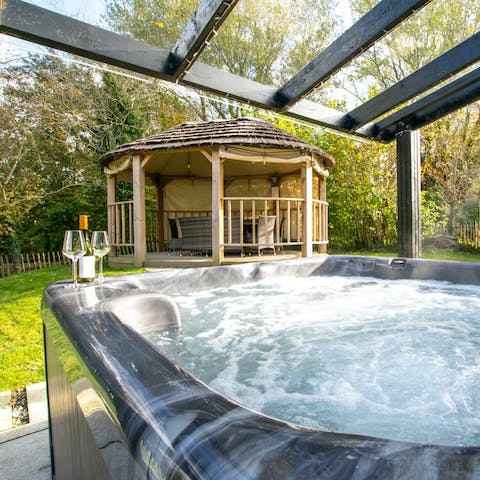 Enjoy a glass of wine in the hot tub with its twinkling lights in the secluded garden