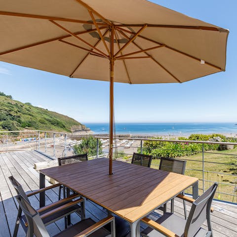 Dine alfresco on your private terrace overlooking the crystal blue coastline