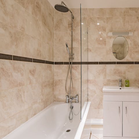 Treat yourself to a long soak in the marble-tiled bathtub
