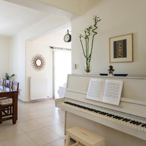 Treat guests to a sing-song around the white upright piano