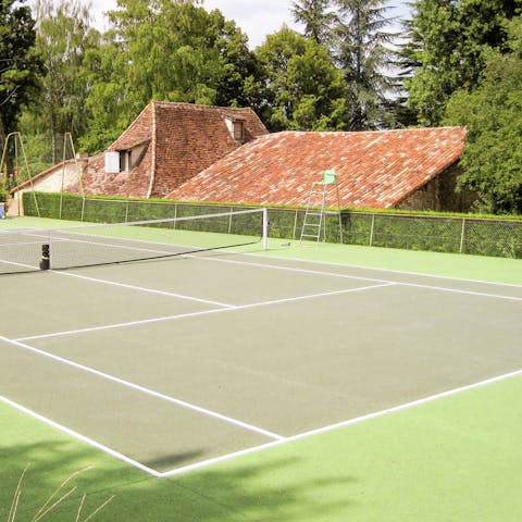 Practise your serve on the villa's private tennis court