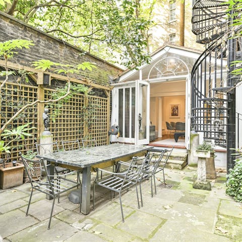 Gather your group for a dinner party out in the private garden
