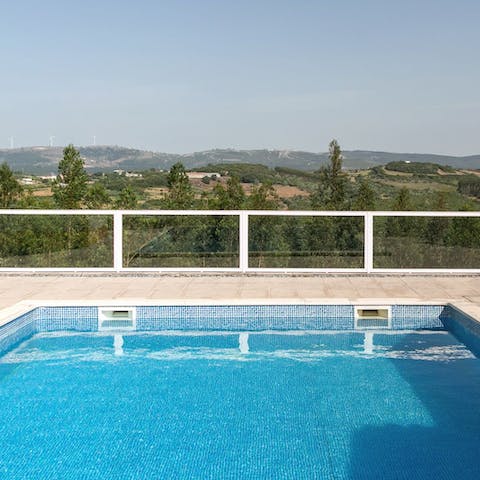 Float on your pristine pool overlooking the tree-studded hills