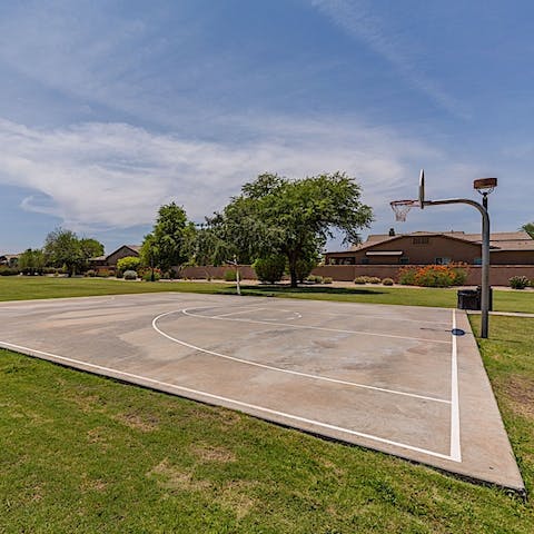 Play a game of basketball on the nearby court