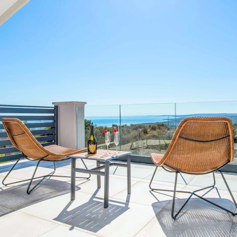 Drink in the sea views over a glass of bubbly on the balcony