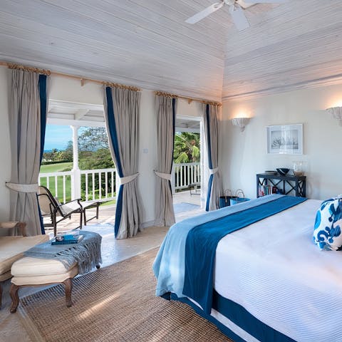 Admire beautiful views across the lush tropical landscape from the master suite