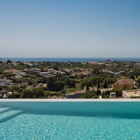 Take in the vistas over the sea and the Marbella golf valley of Nueva Andalucia from the pool