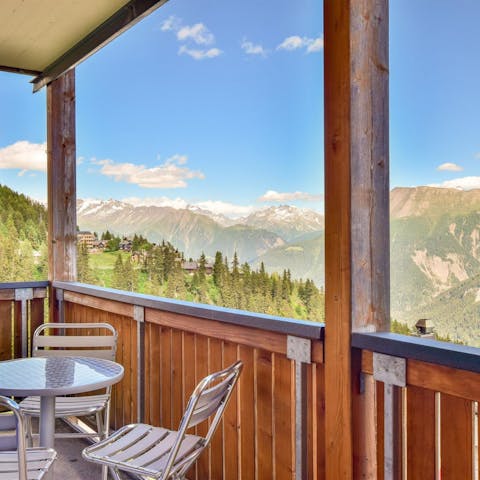 Look out across the Swiss mountains from your covered terrace