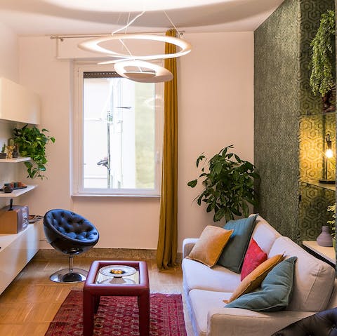 Relax in the stylish living room with a glass of Italian wine after a day of exploring the city