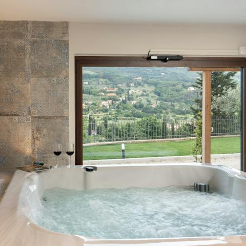 Sit back and enjoy a glass of wine in the hot tub as you take in the views