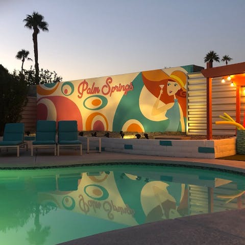 Admire the colourful mural, lit up at night
