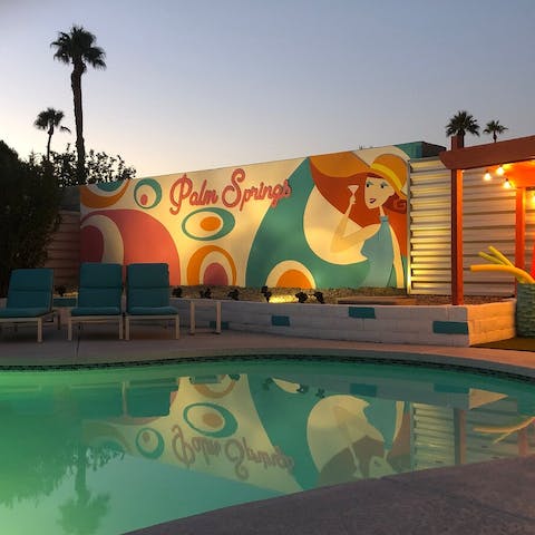 Admire the colourful mural, lit up at night
