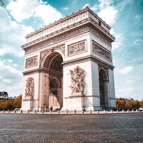 Visit the iconic Arc de Triumph, a sixteen-minute walk away