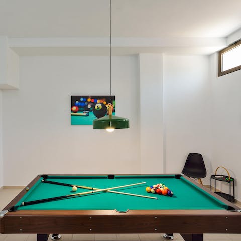 Start a fierce rivalry among fellow guests on the billiards table