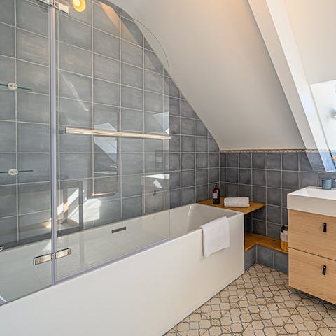 Sink back into piping hot water in the home's boxy bathtub