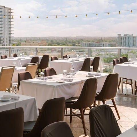 Grab a sunny table for breakfast on the hotel's shared rooftop restaurant