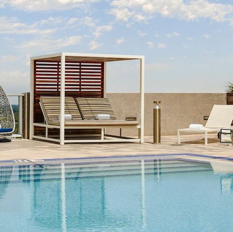 Lose yourself to a good book or just the views from the shared poolside cabanas