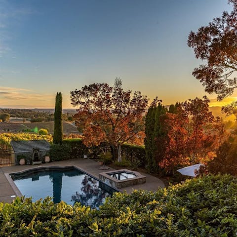 Enjoy stunning sunsets and vineyard views from the pool and hot tub