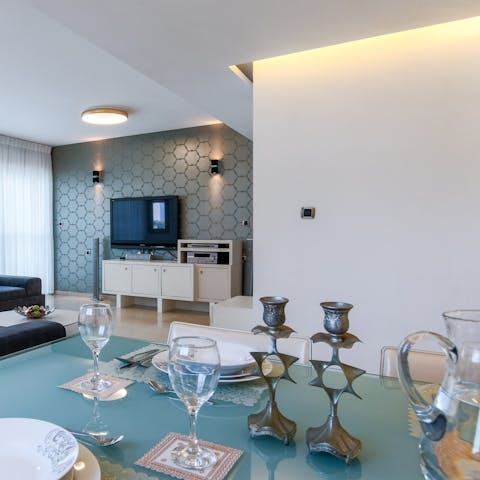 Lay the table for an evening meal in the free-flowing living space
